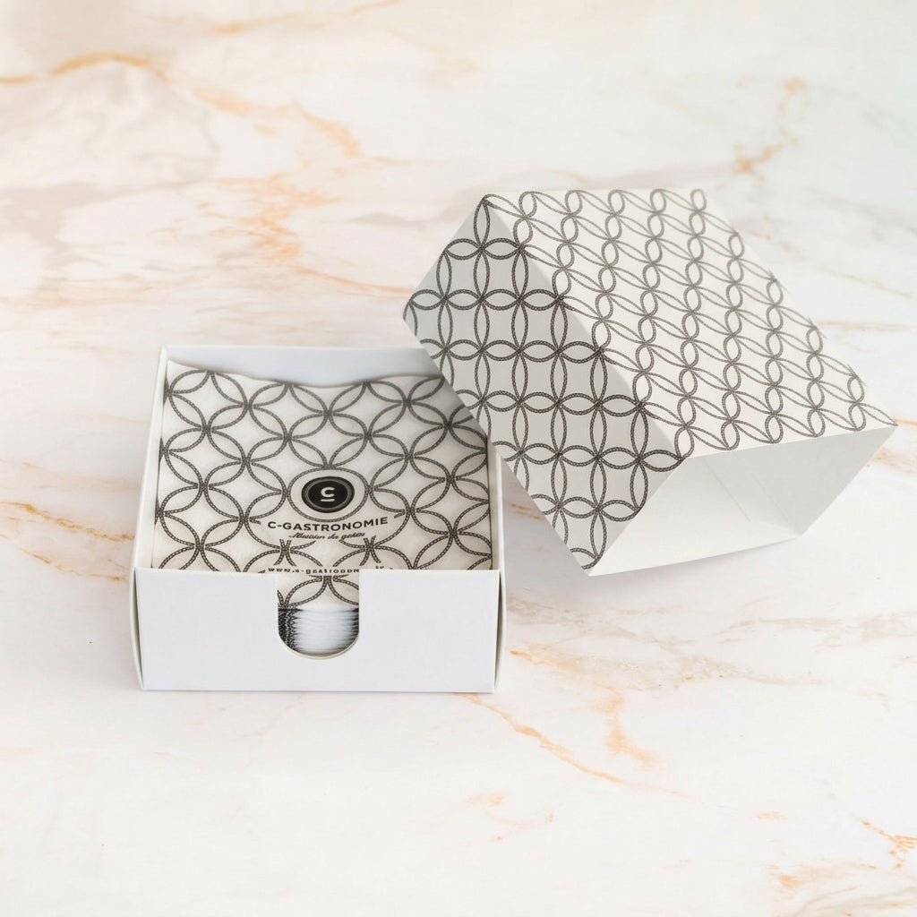Box of C-Gastronomie cocktail napkins on marble