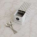 Box of C-Gastronomie stainless steel cocktail spoons on marble