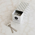 Box of C-Gastronomie stainless steel cocktail forks on marble