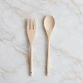 Wooden salad serving set on marble