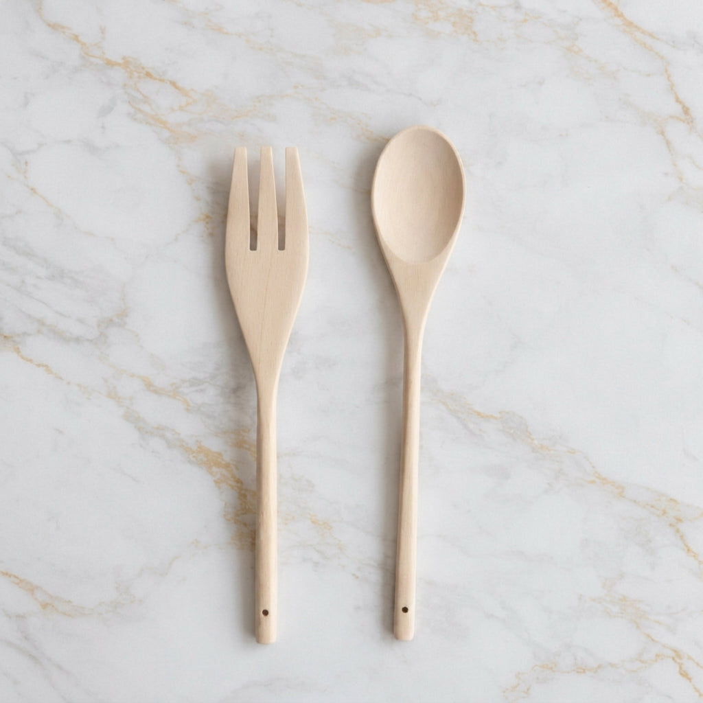 Wooden salad serving set on marble