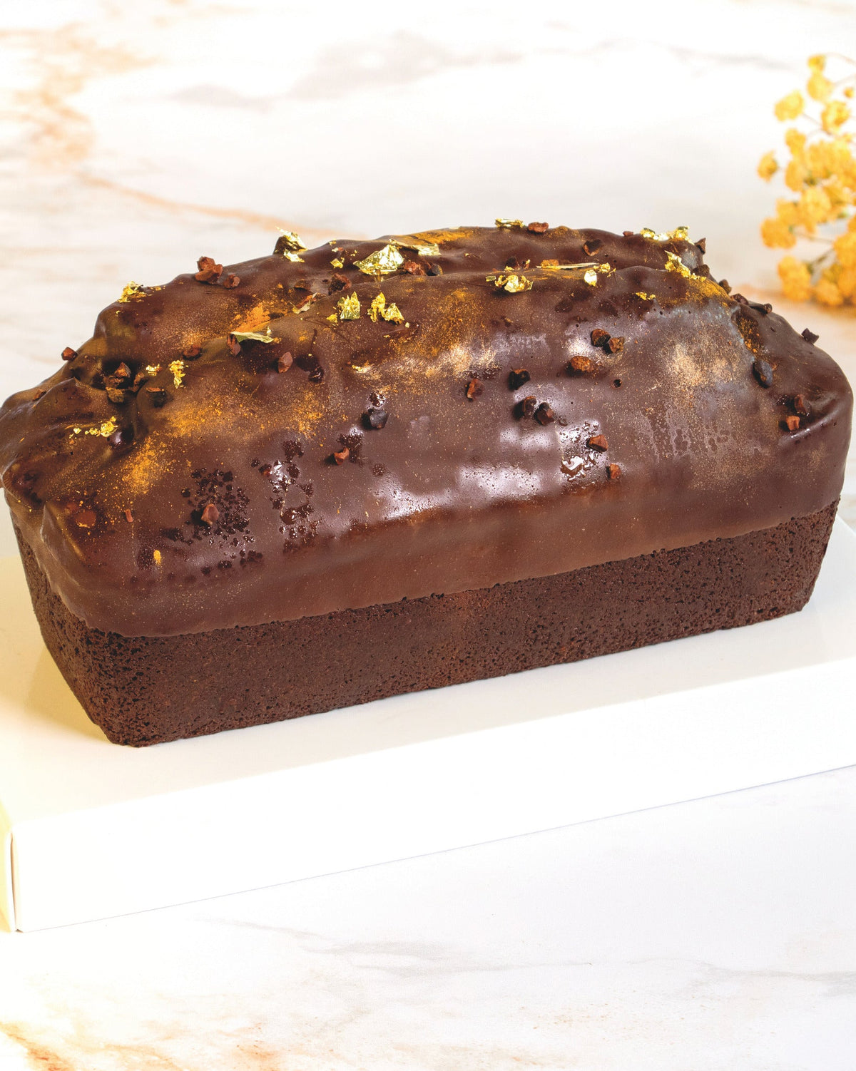 Dark chocolate cake with gold leaf, prepared by C-Gastronomie in Abu Dhabi