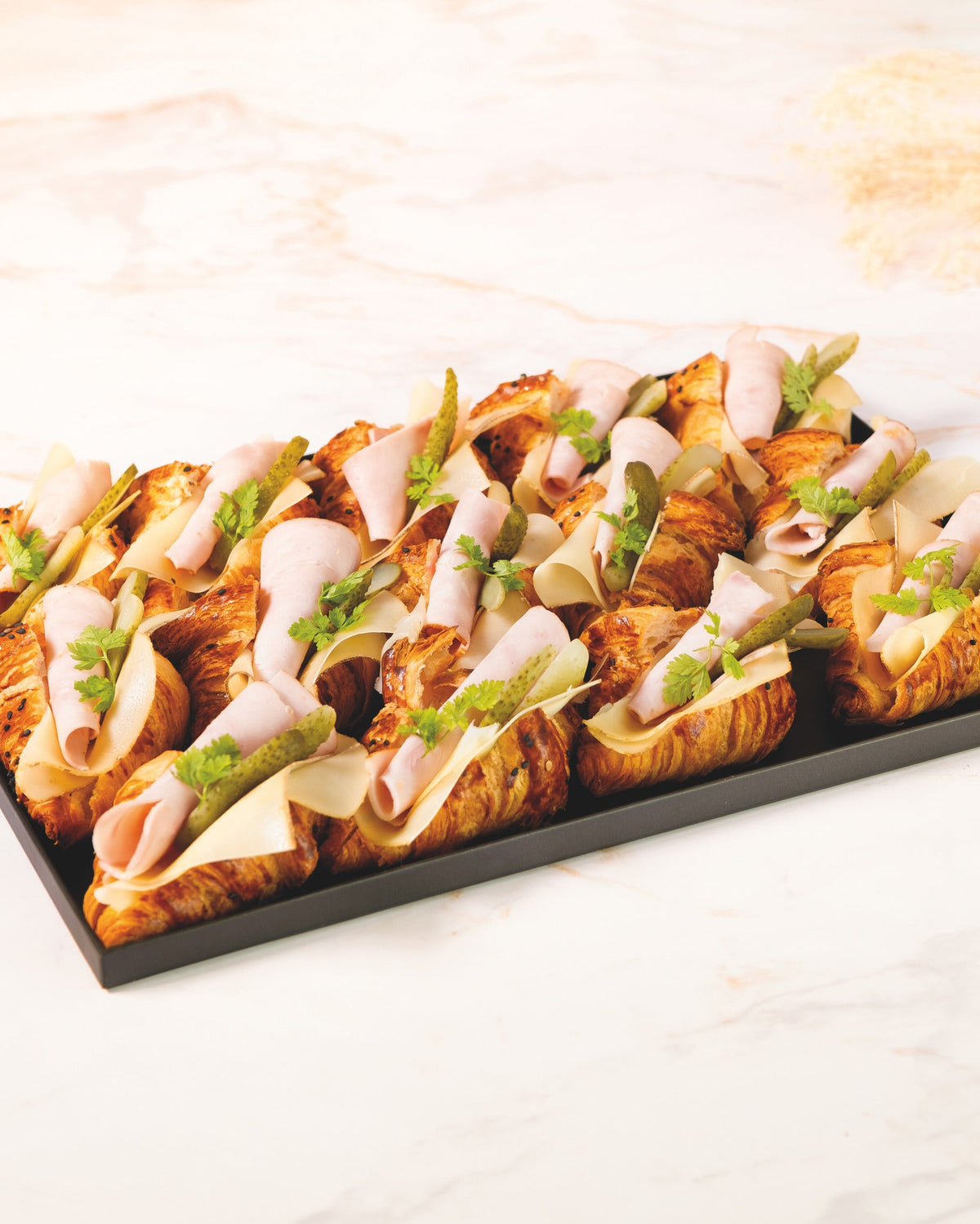 Ham and Comte croissant platter, prepared by C-Gastronomie in Abu Dhabi