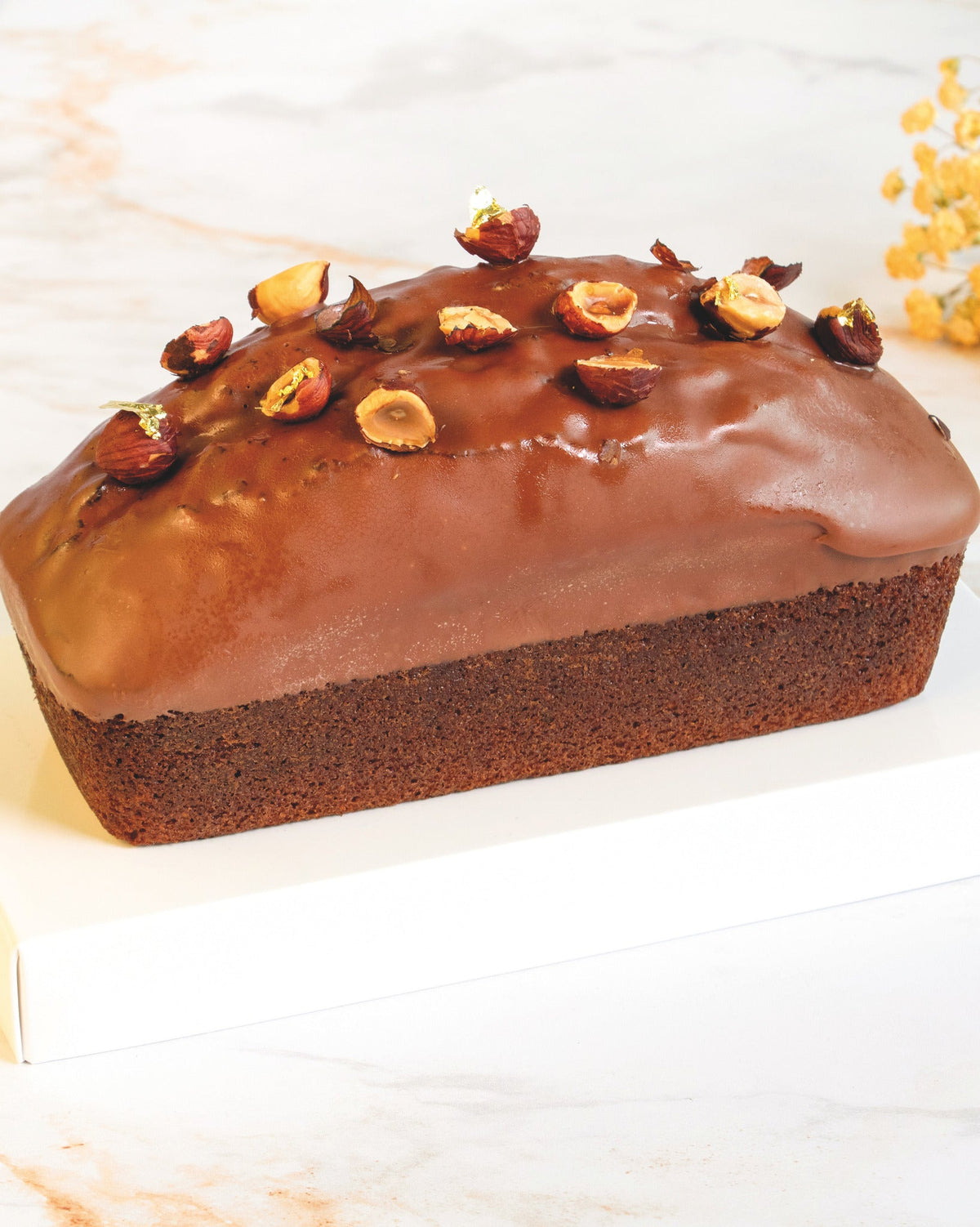 Milk chocolate and hazelnut chunks cake, prepared by C-Gastronomie in Abu Dhabi