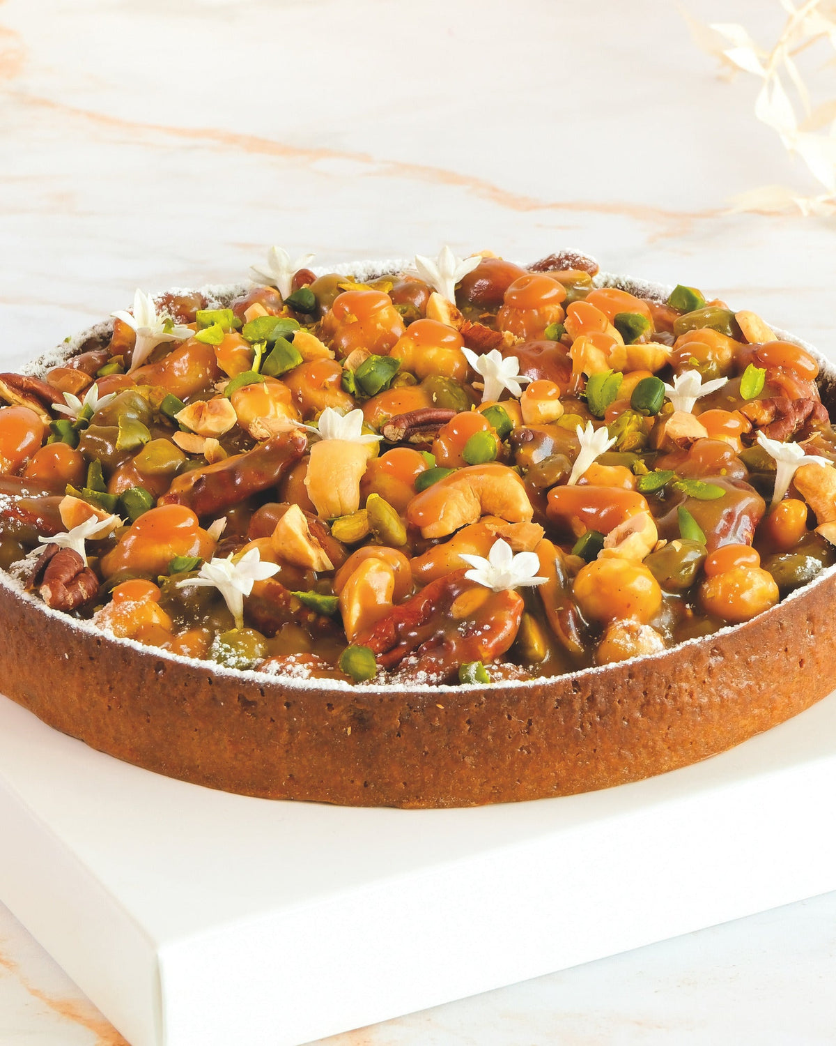 Nut and caramel tart, prepared by C-Gastronomie in Abu Dhabi