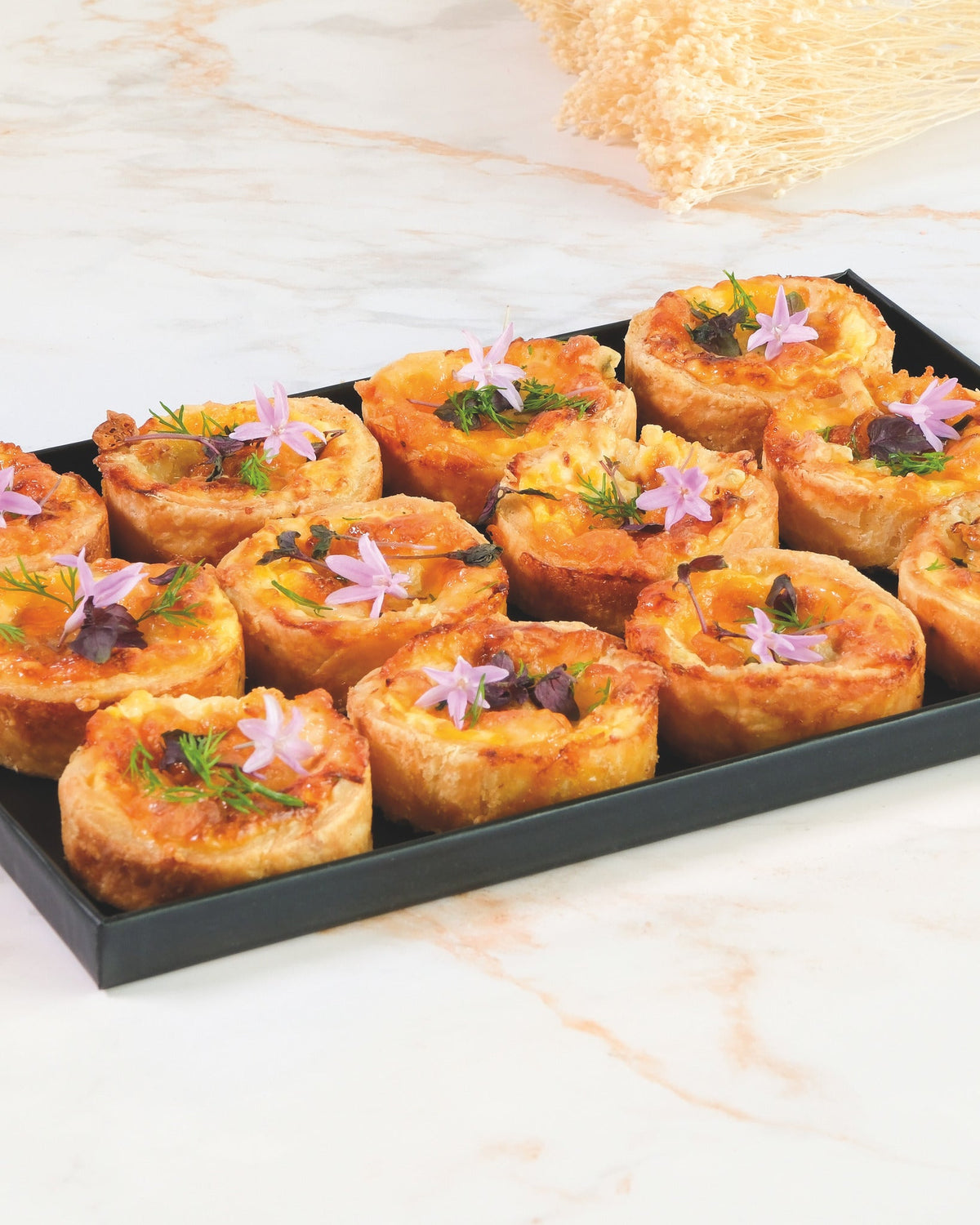 Three-cheese quiche platter, prepared by C-Gastronomie in Abu Dhabi